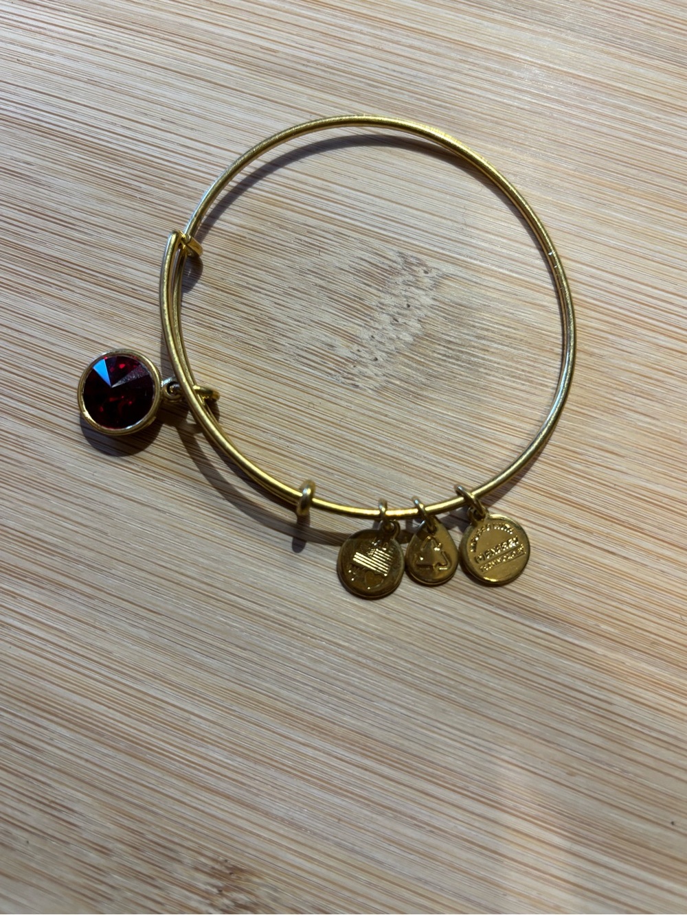 Gold Tone Bangle with Deep Red Crystal Like Charm
